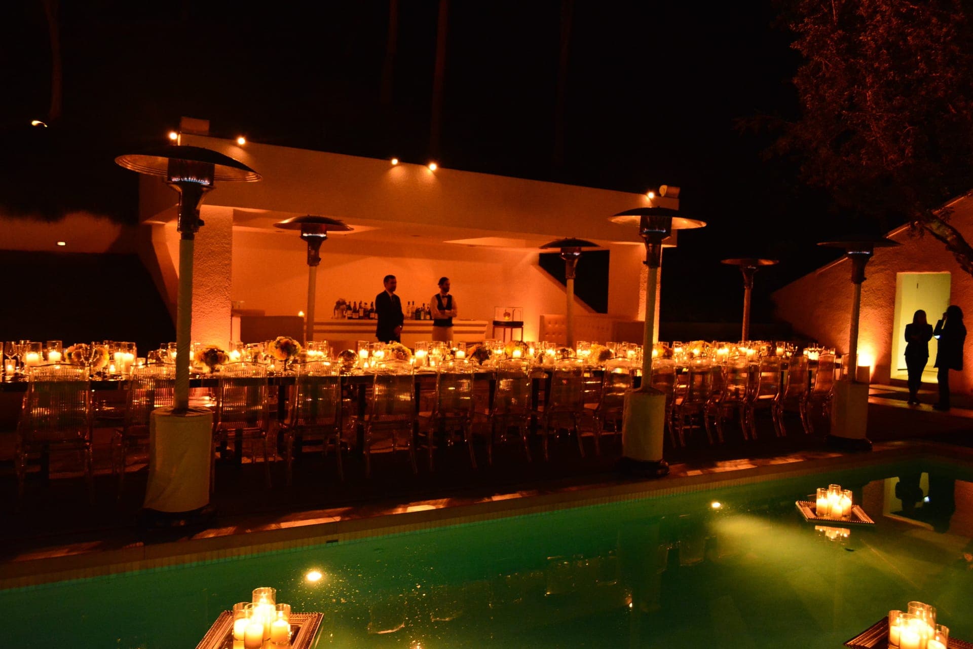 A poolside dinner glowing in candlelight, produced by Just Dance Events
